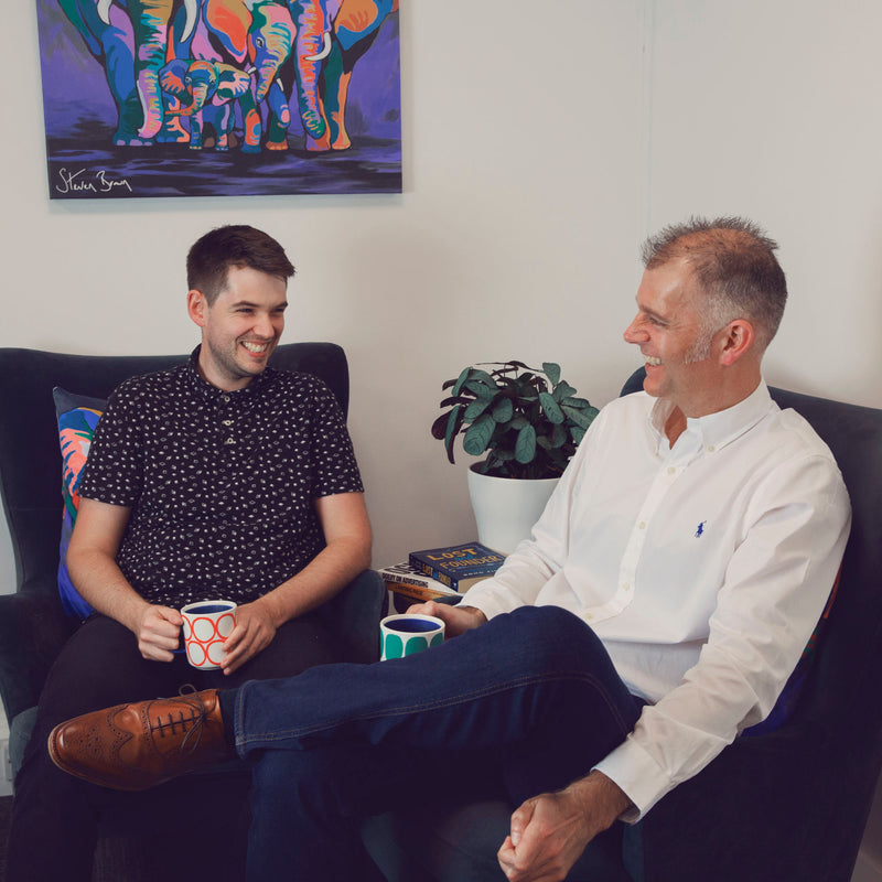 jon and adam enjoying a game of football in the break room