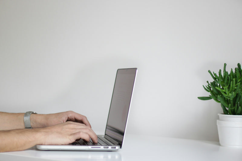 A person typing on a laptop