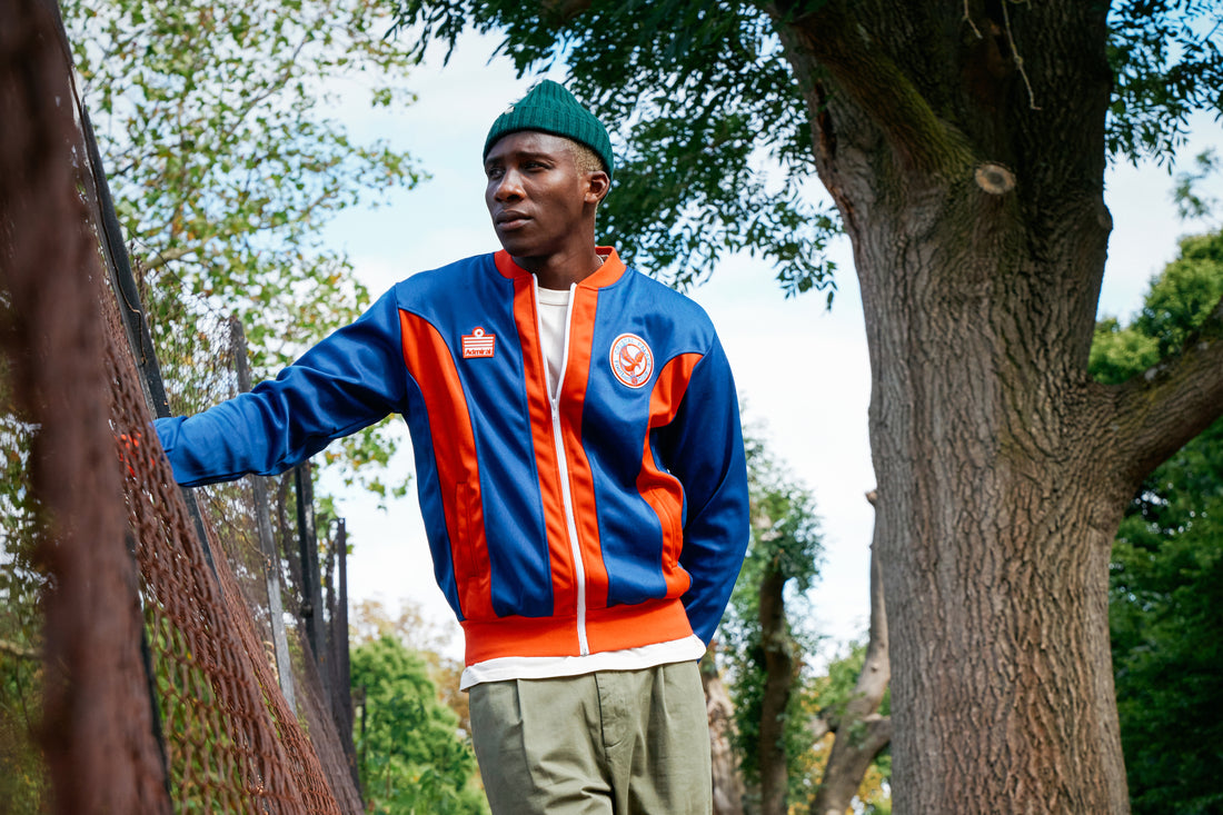 Man next to tree wearing Admiral Sports Crystal Palace FC jacket