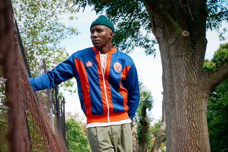 Man next to tree wearing Admiral Sports Crystal Palace FC jacket